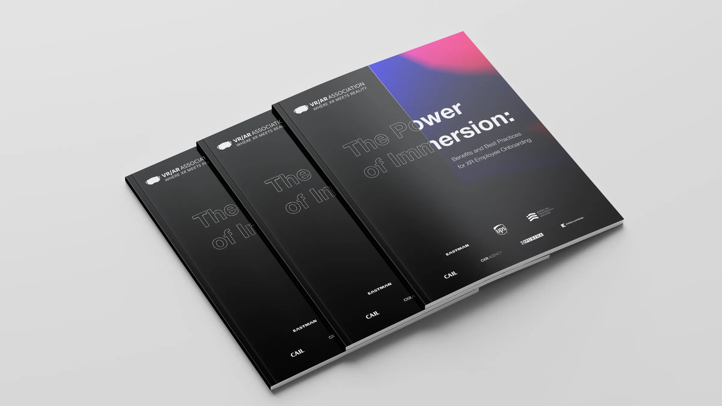 Three copies of the whitepaper fanned in a stack, gradient cover on top